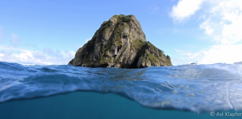 Eerie faces caved into one of the islands at Isla Del Coco